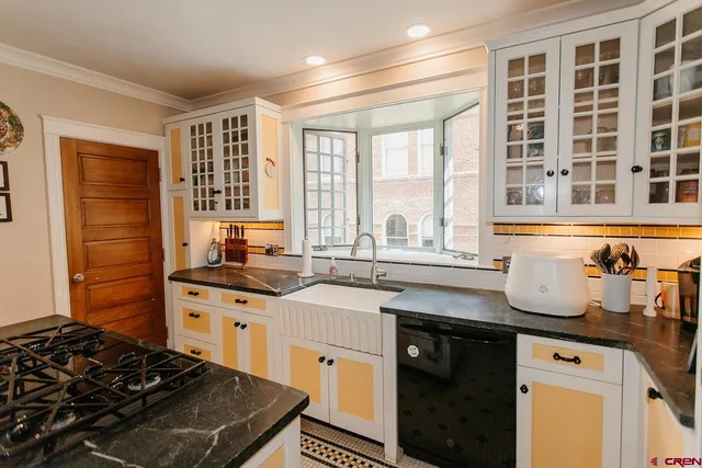 a kitchen with granite countertop a stove and a sink