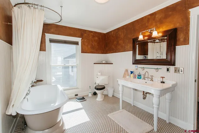 a bathroom with a sink toilet and mirror