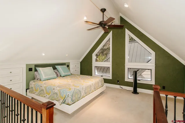 a bedroom with a bed a dresser and window