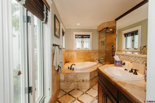 a bathroom with a tub sink and mirror