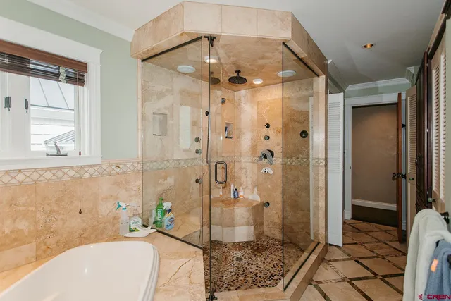 a bathroom with a bathtub and shower