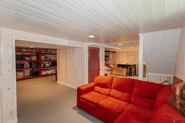a view of backyard with table and chairs and potted plants