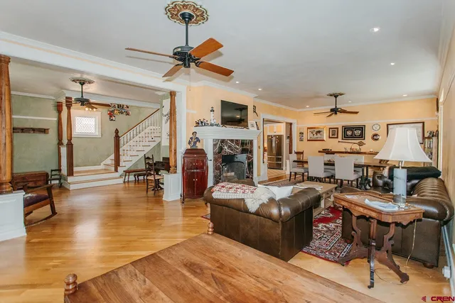 a living room with fireplace furniture and a wooden floor