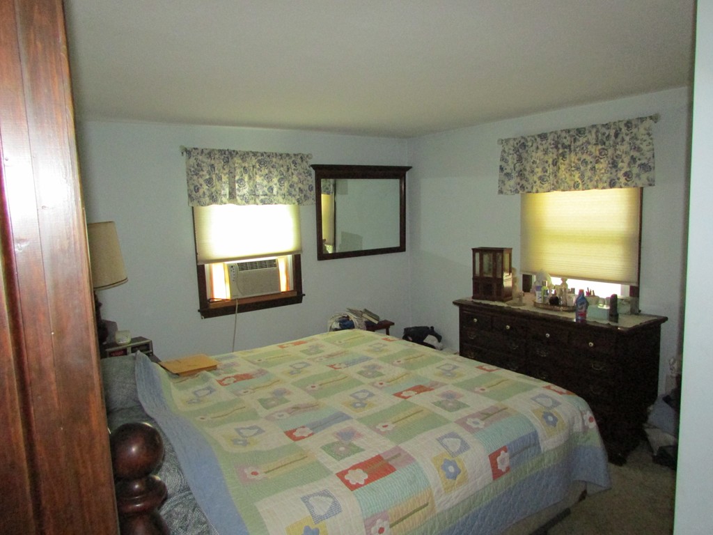 89 Clement Street Springfield, MA 01118 - Photo 11 of 14 a bedroom with a bed and a flat screen tv