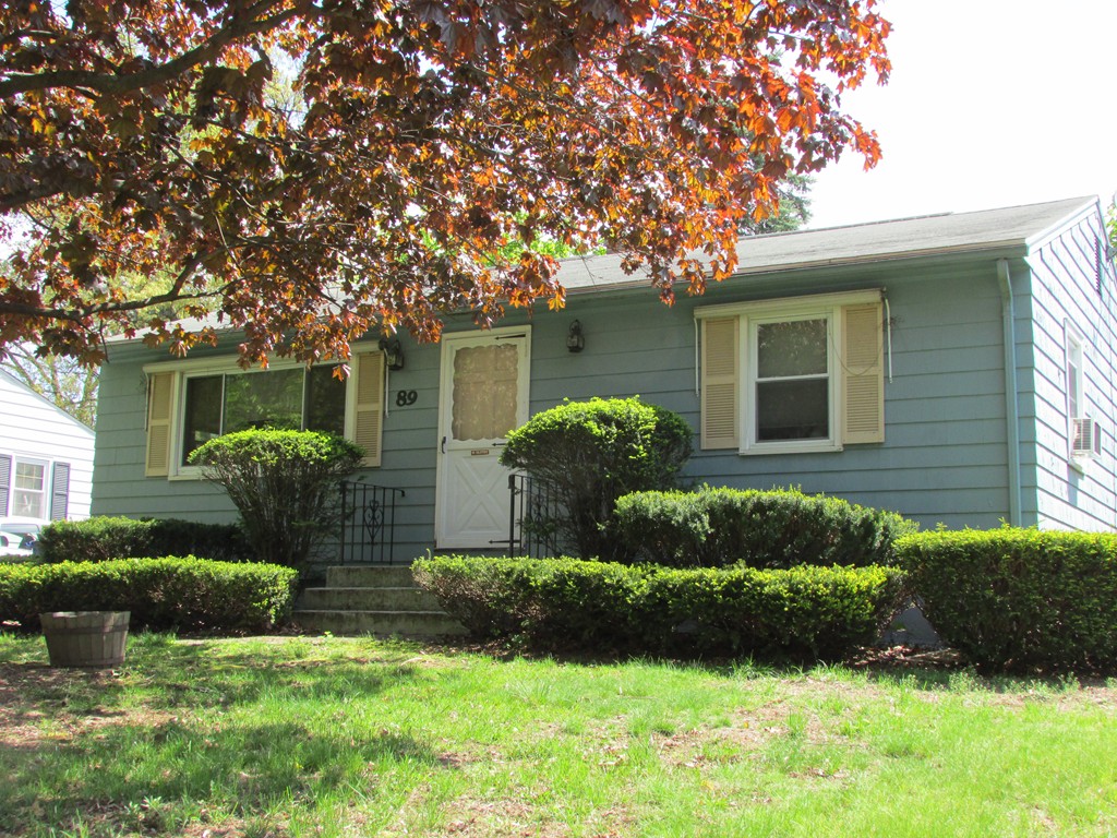 89 Clement Street Springfield, MA 01118 - Photo 2 of 14 a front view of a house with a yard and outdoor seating