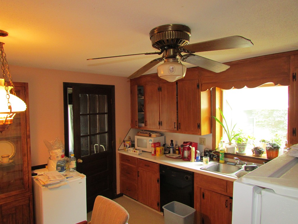 89 Clement Street Springfield, MA 01118 - Photo 6 of 14 a kitchen with stainless steel appliances a sink cabinets and wooden floor