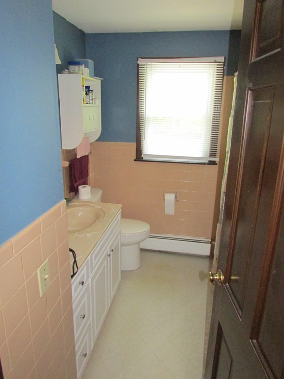 89 Clement Street Springfield, MA 01118 - Photo 10 of 14 a bathroom with a granite countertop sink toilet and a shower