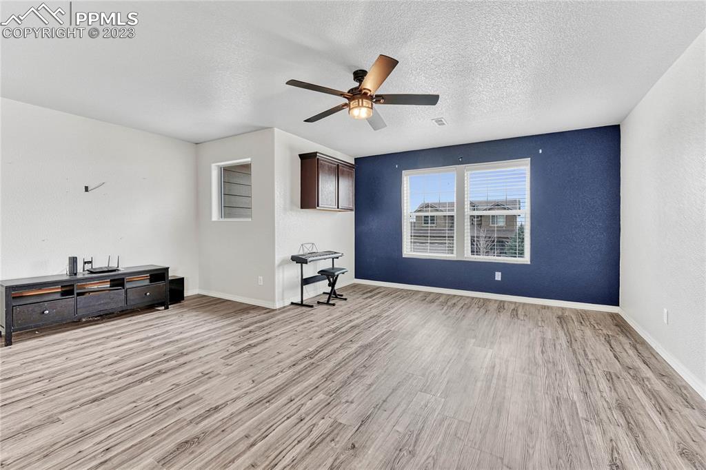 1064 Diamond Rim Drive Colorado Springs, CO 80921 - Photo 12 of 30 a view of a livingroom with a hardwood floor and a ceiling fan