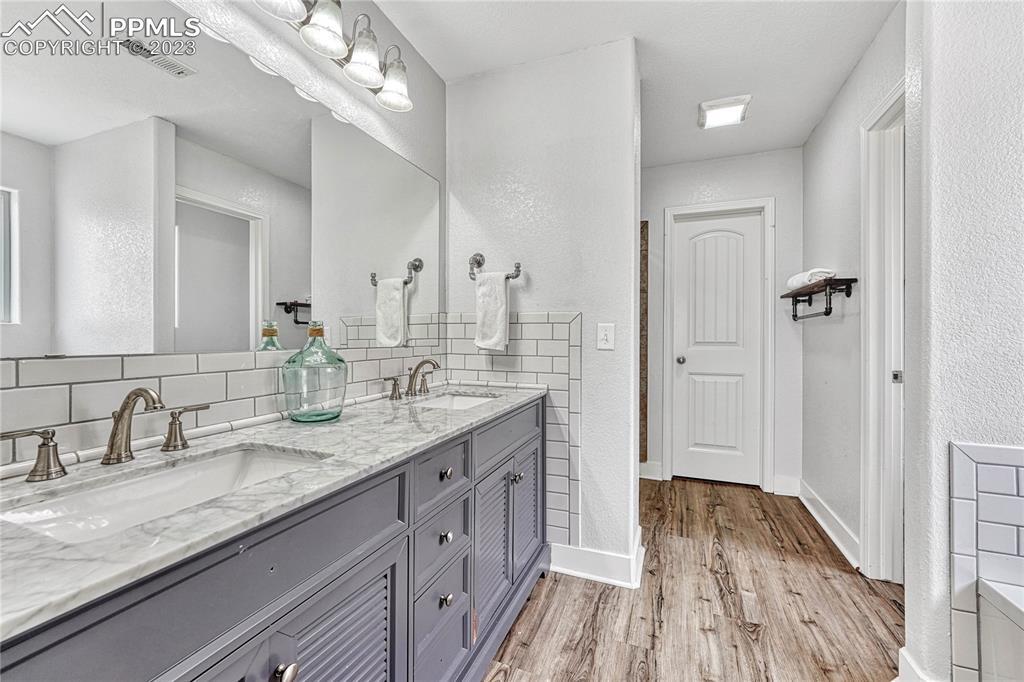 1064 Diamond Rim Drive Colorado Springs, CO 80921 - Photo 15 of 30 a bathroom with double vanity sinks a vanity and a mirror