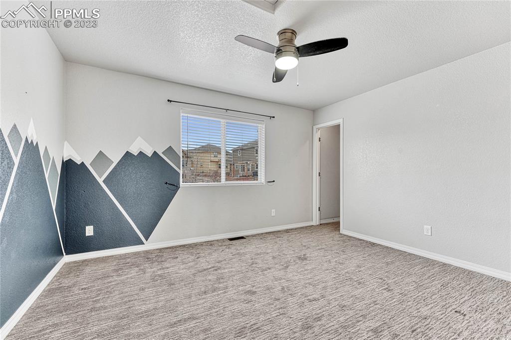 1064 Diamond Rim Drive Colorado Springs, CO 80921 - Photo 19 of 30 an empty room with windows and ceiling fan
