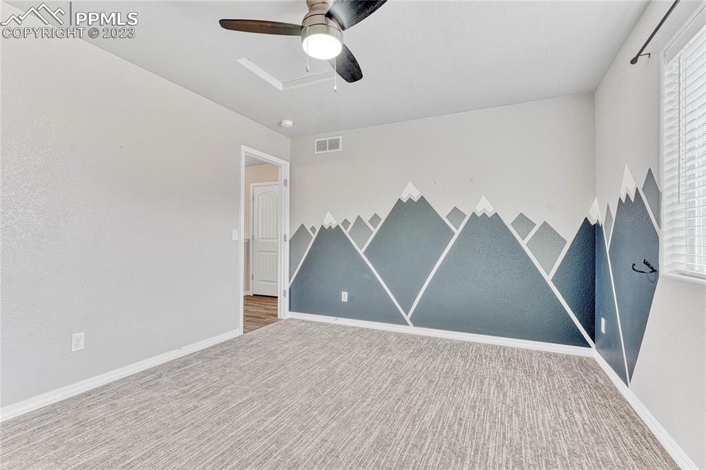 1064 Diamond Rim Drive Colorado Springs, CO 80921 - Photo 20 of 30 a view of an empty room with wooden floor