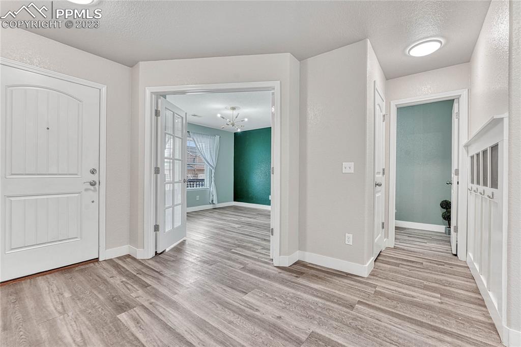 1064 Diamond Rim Drive Colorado Springs, CO 80921 - Photo 2 of 30 a view of a hallway with wooden floor