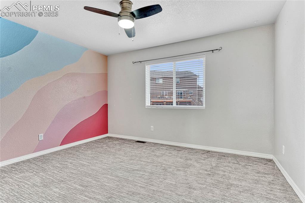 1064 Diamond Rim Drive Colorado Springs, CO 80921 - Photo 21 of 30 a view of an empty room with wooden floor and a window