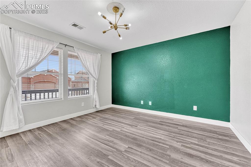 1064 Diamond Rim Drive Colorado Springs, CO 80921 - Photo 3 of 30 a view of an empty room with a window and a kitchen