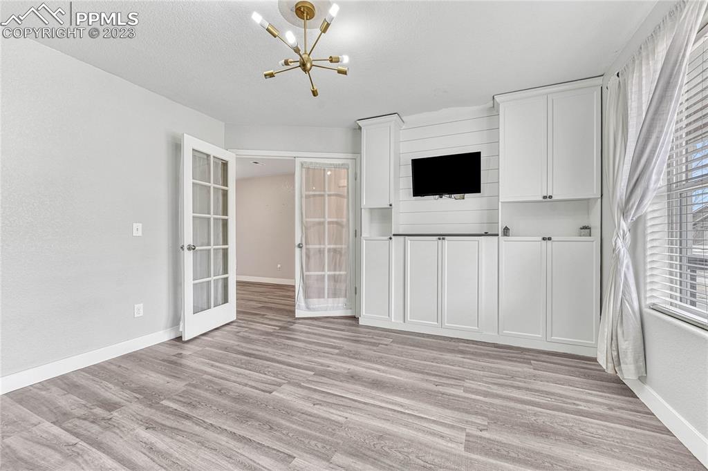 1064 Diamond Rim Drive Colorado Springs, CO 80921 - Photo 4 of 30 a view of a livingroom with wooden floor and white walls