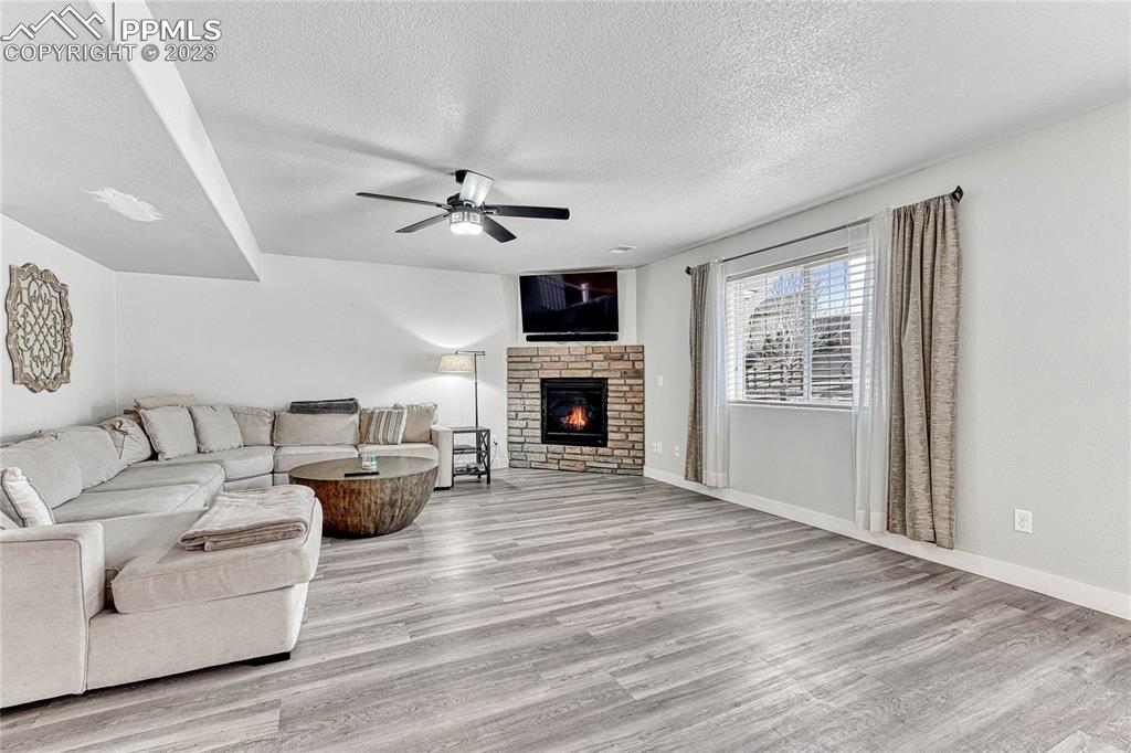 1064 Diamond Rim Drive Colorado Springs, CO 80921 - Photo 5 of 30 a living room with furniture fireplace and flat screen tv