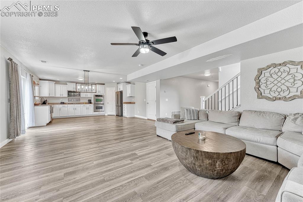 1064 Diamond Rim Drive Colorado Springs, CO 80921 - Photo 7 of 30 a living room with furniture and a wooden floor