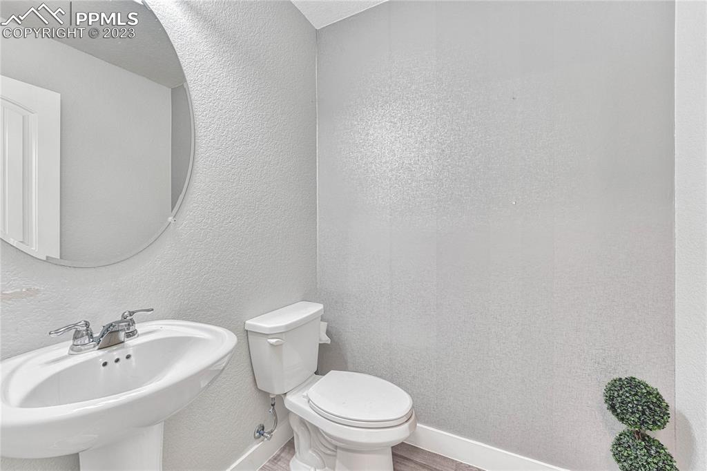 1064 Diamond Rim Drive Colorado Springs, CO 80921 - Photo 10 of 30 a bathroom with a sink a toilet and mirror