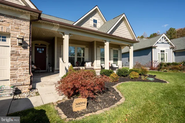 a view of a house with potted plants and more windows