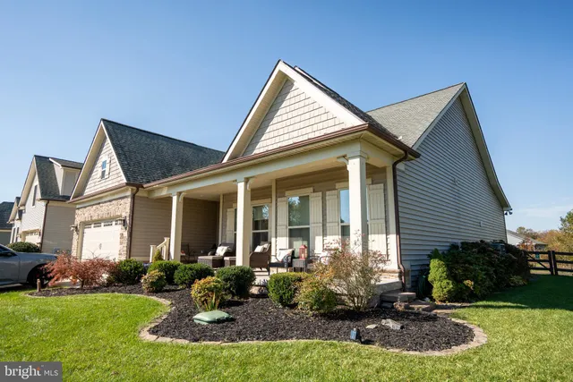 a view of a house with a yard patio and fire pit