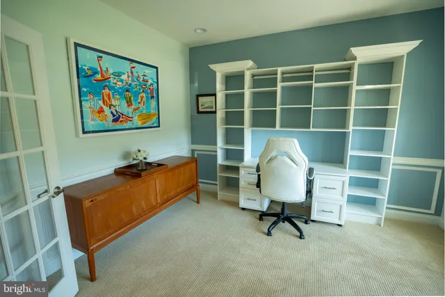 a living room with a couch and a workspace