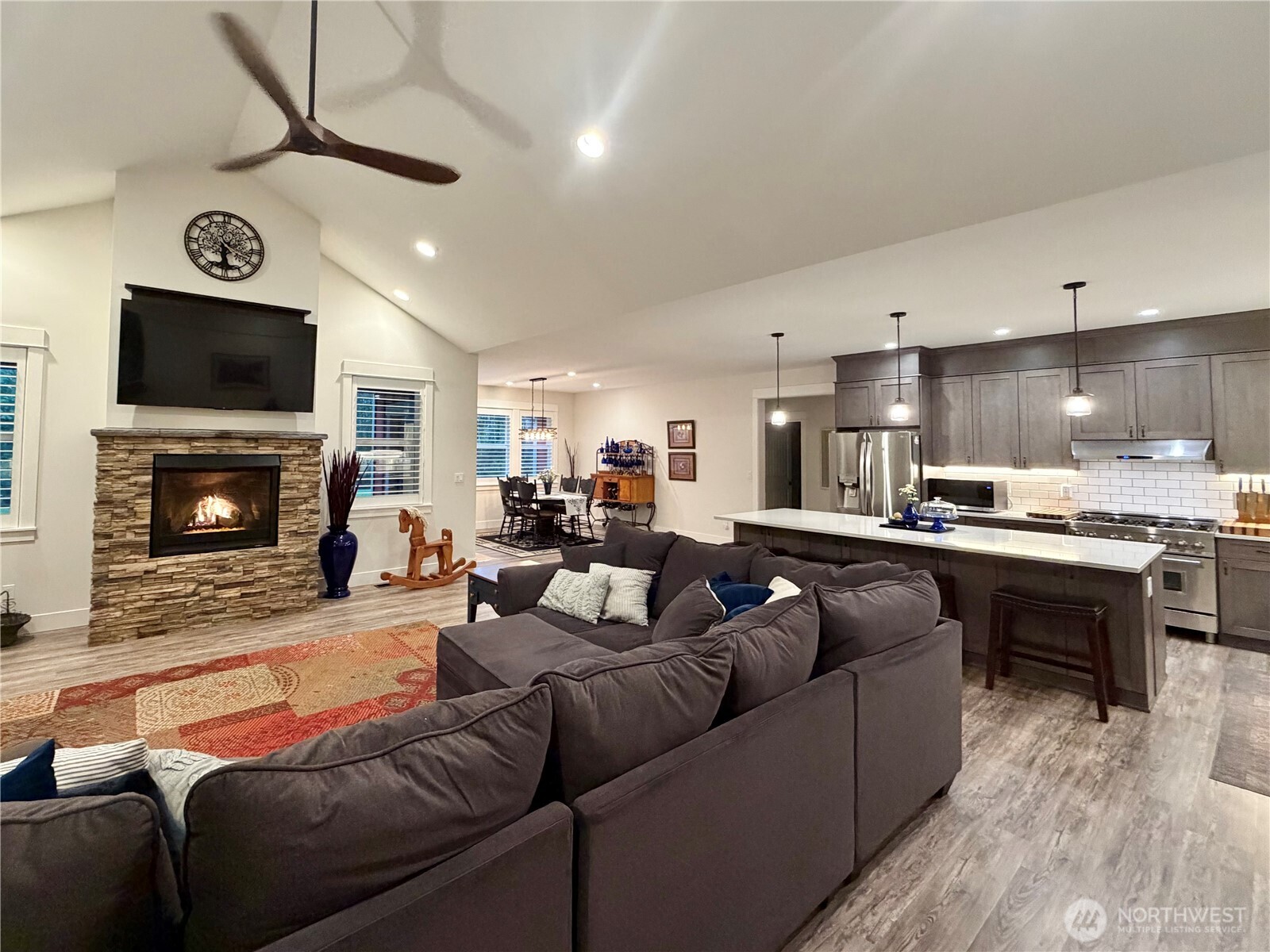 18349 Northwest Stavis Bay Road Seabeck, WA 98380 - Photo 12 of 40 a living room with furniture a flat screen tv and a fireplace