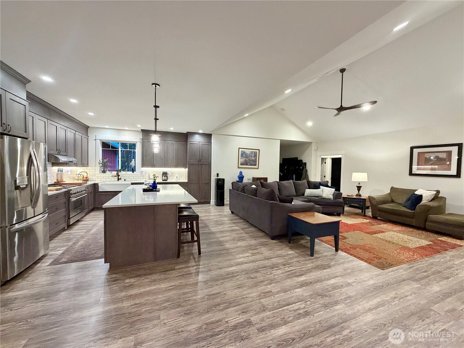 18349 Northwest Stavis Bay Road Seabeck, WA 98380 - Photo 13 of 40 a living room with furniture kitchen area and a wooden floor