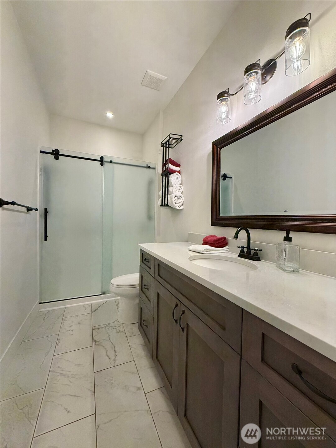 18349 Northwest Stavis Bay Road Seabeck, WA 98380 - Photo 24 of 40 a bathroom with a sink a toilet and mirror