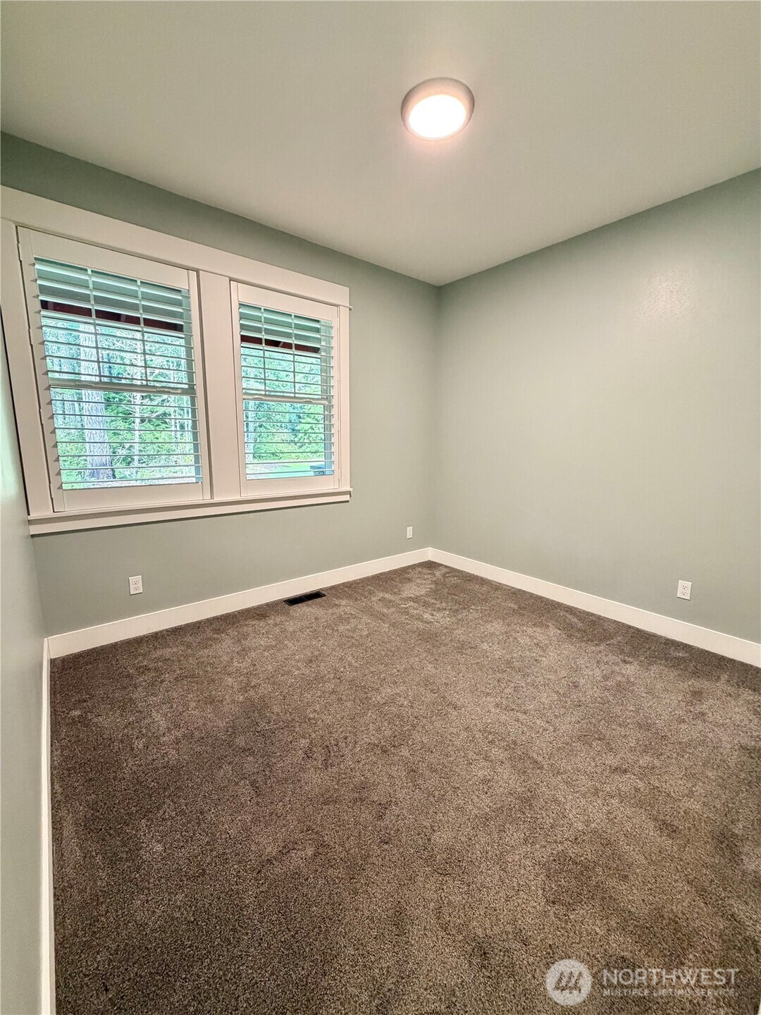 18349 Northwest Stavis Bay Road Seabeck, WA 98380 - Photo 27 of 40 an empty room with a window