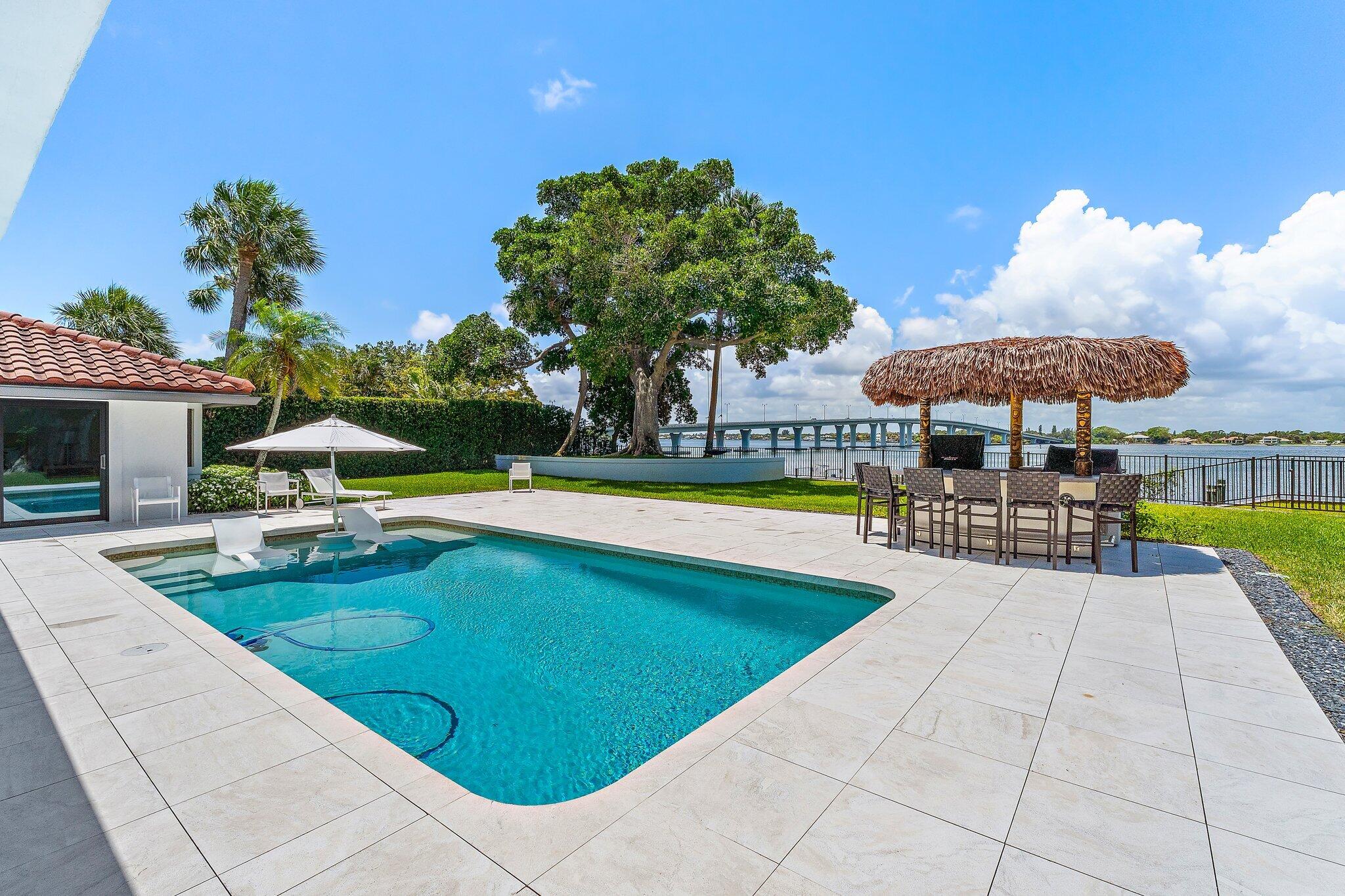 9 North River Road Stuart, FL 34996 - Photo 24 of 24 a view of a swimming pool with a patio
