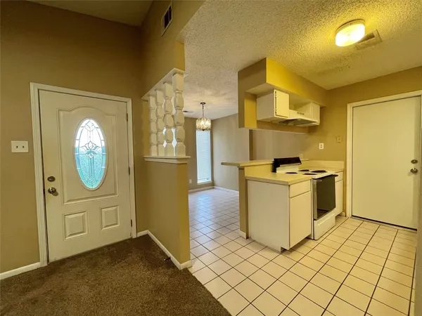 a kitchen with a sink a stove and cabinets