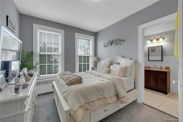 a bedroom with a large bed and a large window