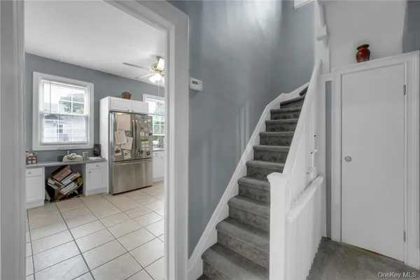 a view of a livingroom with furniture and stairs