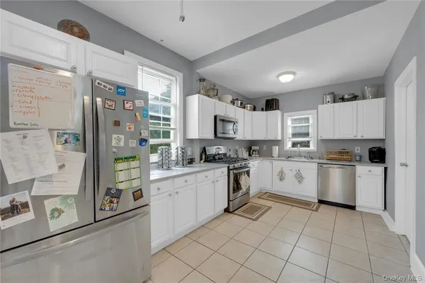 a kitchen with a refrigerator a sink and cabinets
