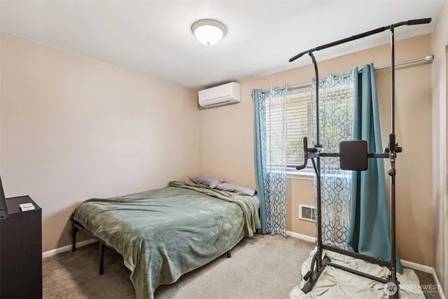 a bedroom with a bed and a mirror