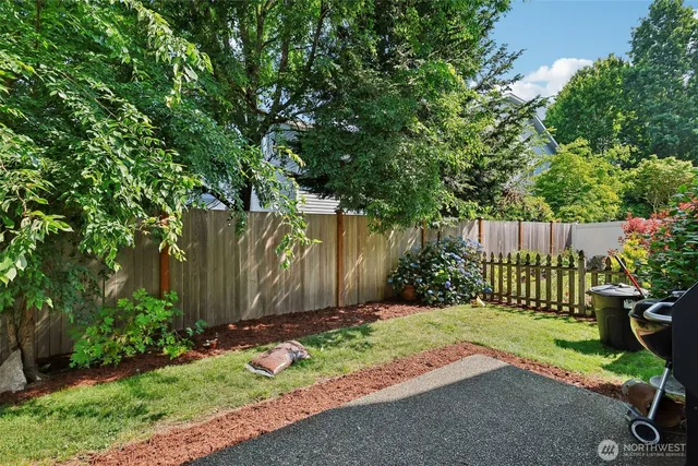 a view of a garden with wooden fence