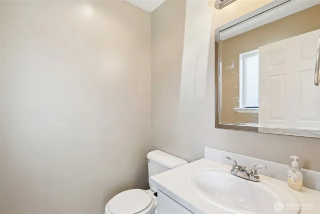 a bathroom with a toilet sink and mirror