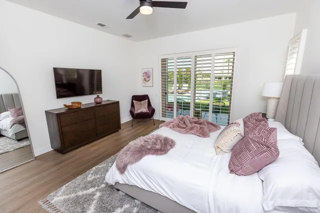 a view of a hallway with wooden floor and glass door