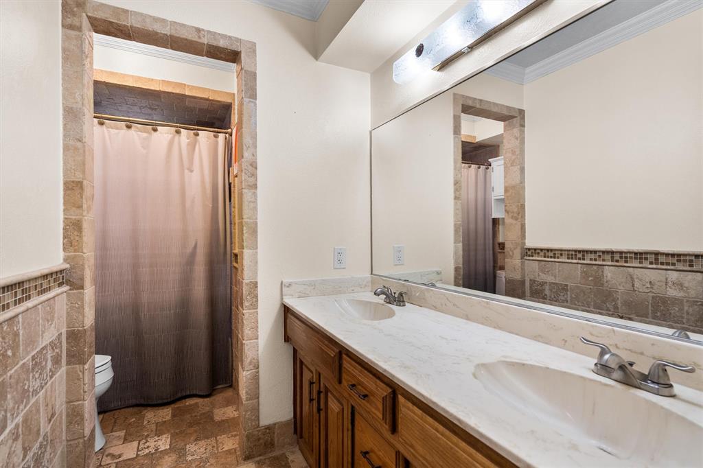 2214 Valley Mill Carrollton, TX 75006 - Photo 28 of 36 a bathroom with a double vanity sink and a mirror