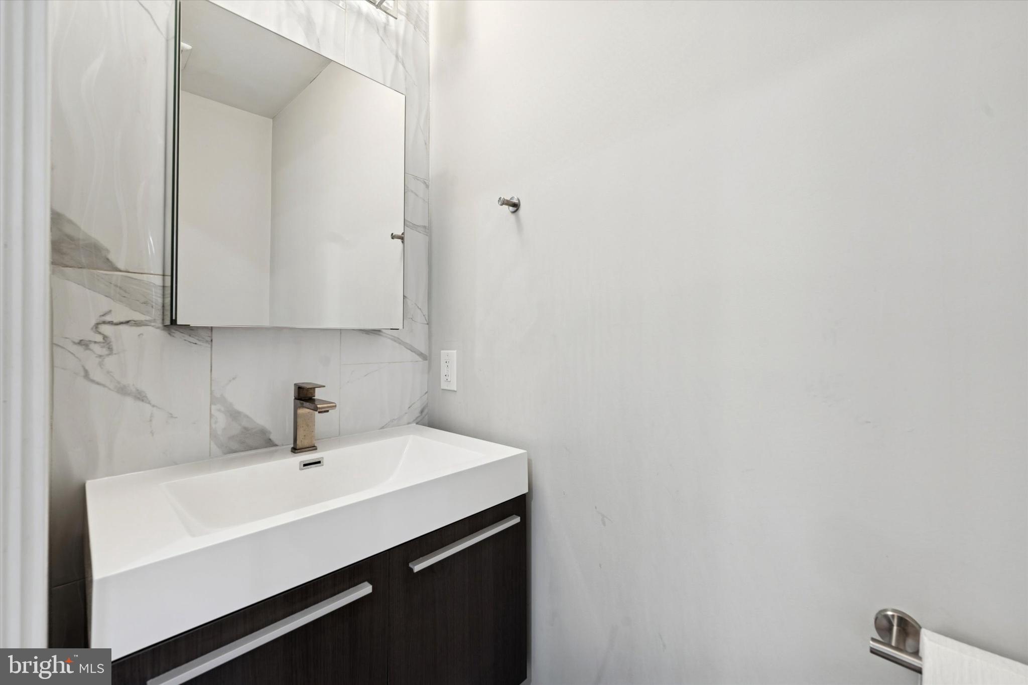 700 Moyer Street, Unit 210 Philadelphia, PA 19125 - Photo 8 of 14 a bathroom with a sink and a mirror