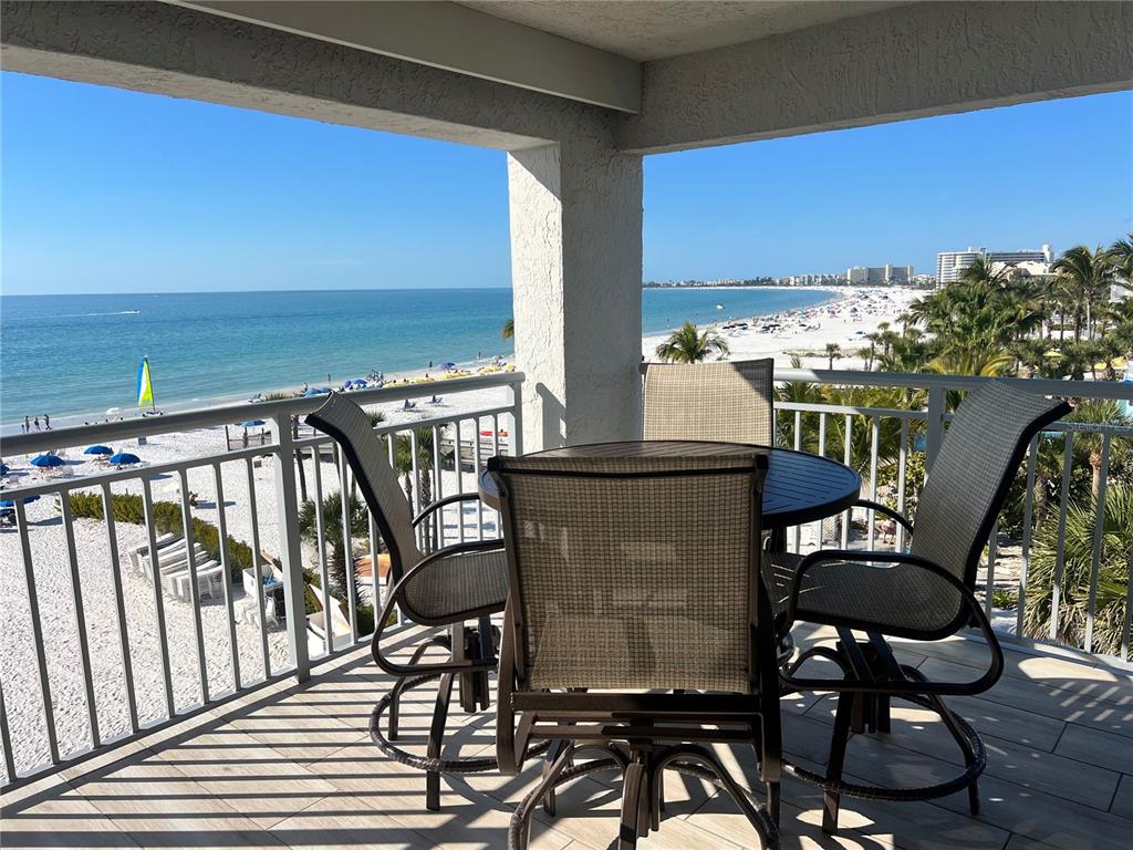 1001 Point Of Rocks Road, Unit 512 Sarasota, FL 34242 - Photo 1 of 44 a balcony with table and chairs
