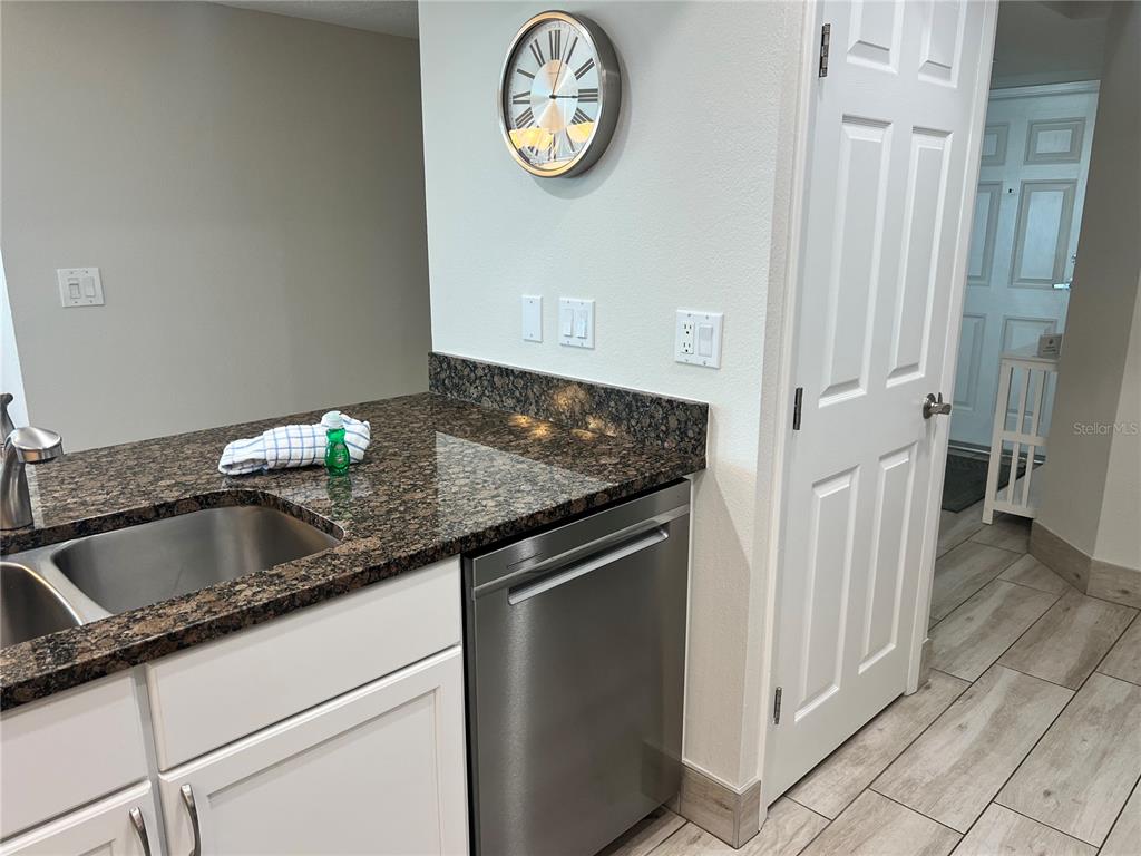 1001 Point Of Rocks Road, Unit 512 Sarasota, FL 34242 - Photo 14 of 44 a kitchen with granite countertop a sink and a stove