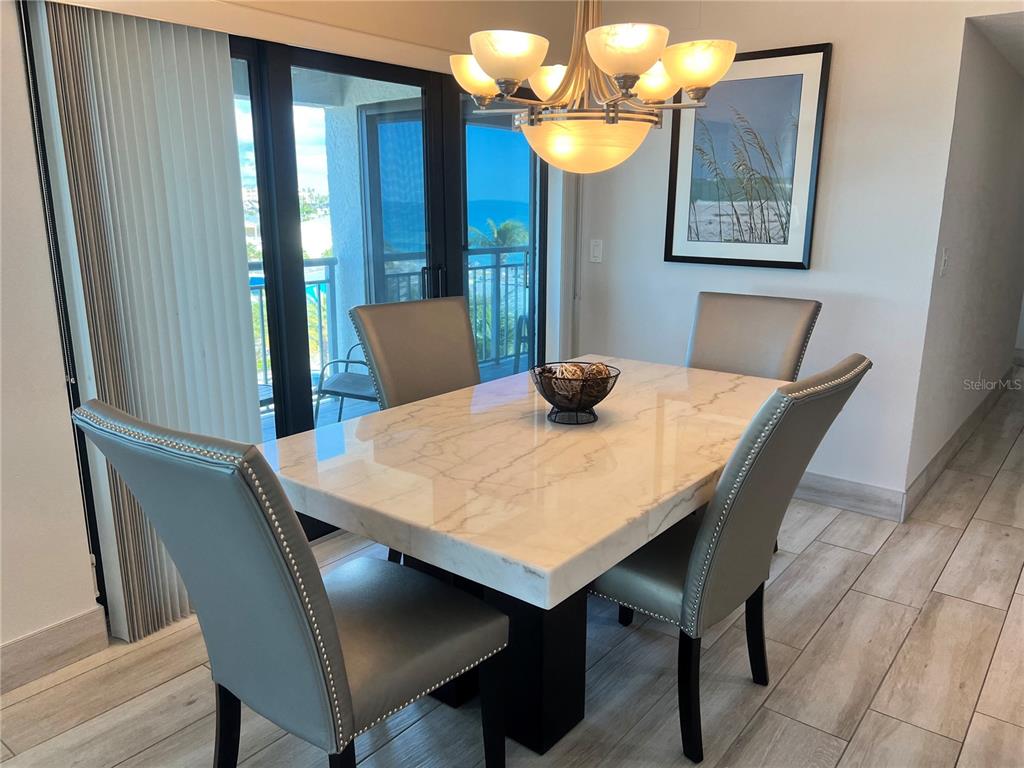 1001 Point Of Rocks Road, Unit 512 Sarasota, FL 34242 - Photo 4 of 44 a view of a dining table and chairs in a room