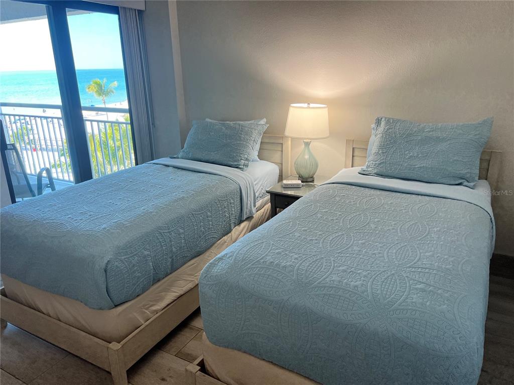 1001 Point Of Rocks Road, Unit 512 Sarasota, FL 34242 - Photo 7 of 44 a bedroom with two beds and large window