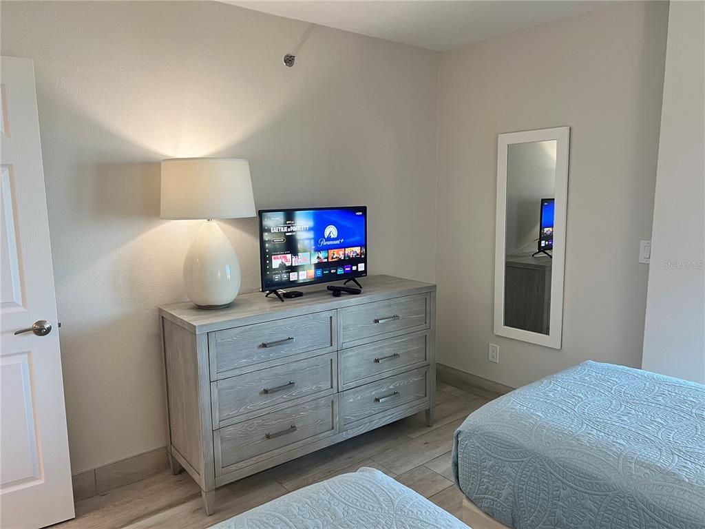1001 Point Of Rocks Road, Unit 512 Sarasota, FL 34242 - Photo 8 of 44 a bedroom with a bed and a television