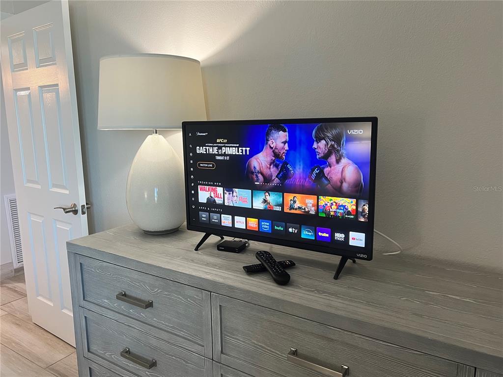 1001 Point Of Rocks Road, Unit 512 Sarasota, FL 34242 - Photo 9 of 44 a living room with furniture and a flat screen tv