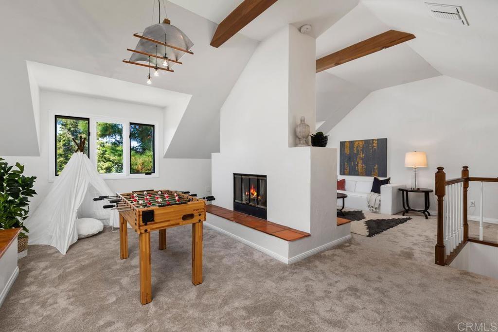 455 Cole Ranch Road Encinitas, CA 92024 - Photo 21 of 43 a living room with furniture and a fireplace