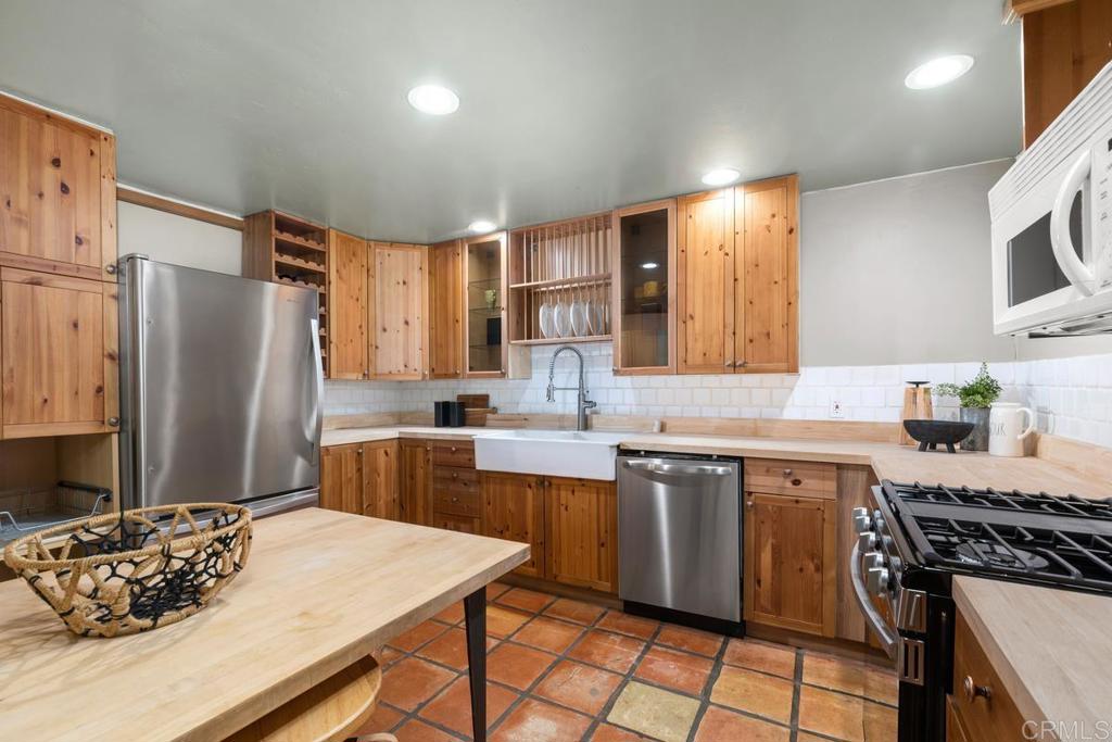 455 Cole Ranch Road Encinitas, CA 92024 - Photo 31 of 43 a kitchen with a sink stove and refrigerator