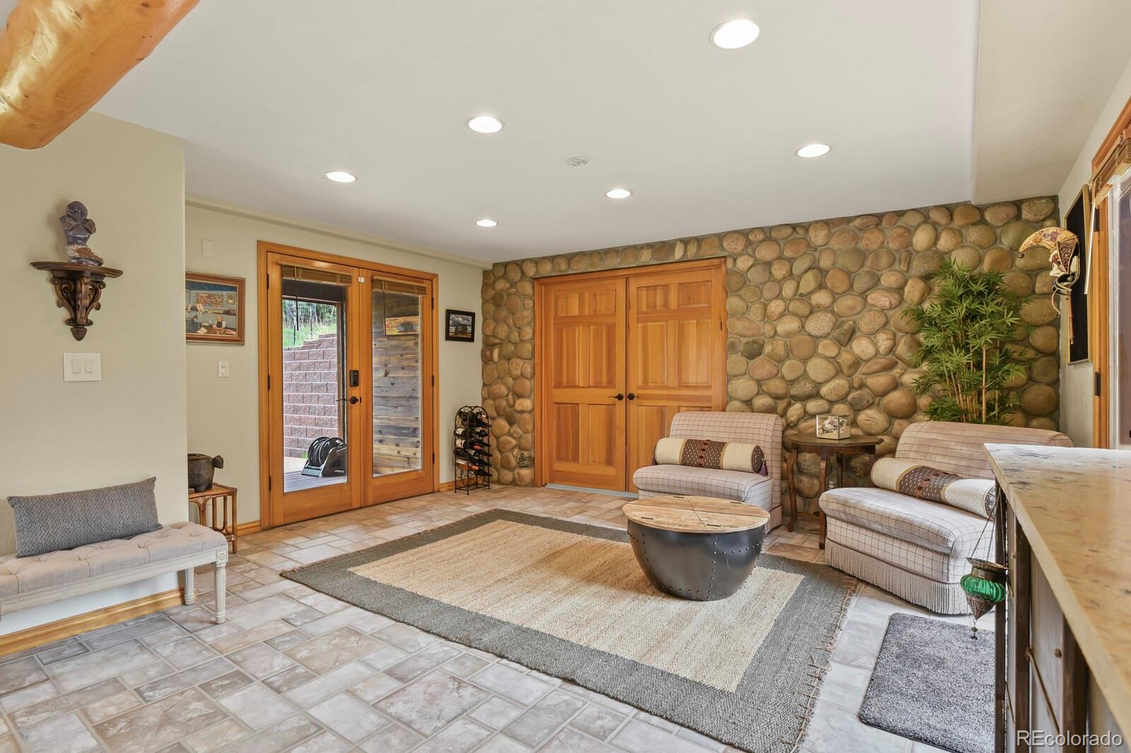 417 Witter Gulch Road Evergreen, CO 80439 - Photo 23 of 50 a living room with furniture and a large window