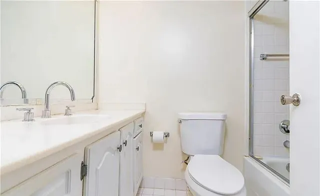 a bathroom with a sink mirror vanity and toilet